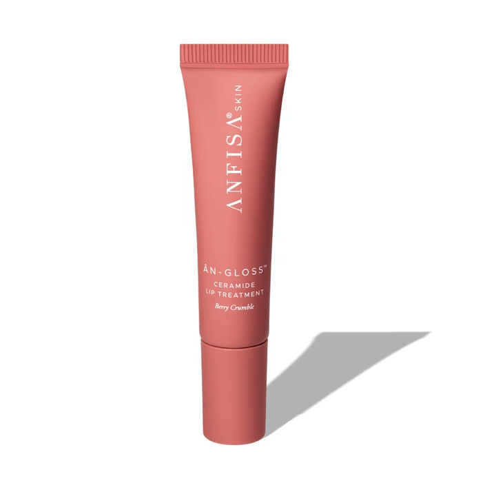 A tube of lip tint with a pink hue, labeled ÀN-GLOSS Ceramide Lip Tint, against a white background.